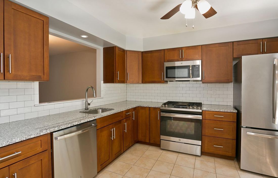 Updated kitchen with shaker cabinets, granite counters and stainless appliances