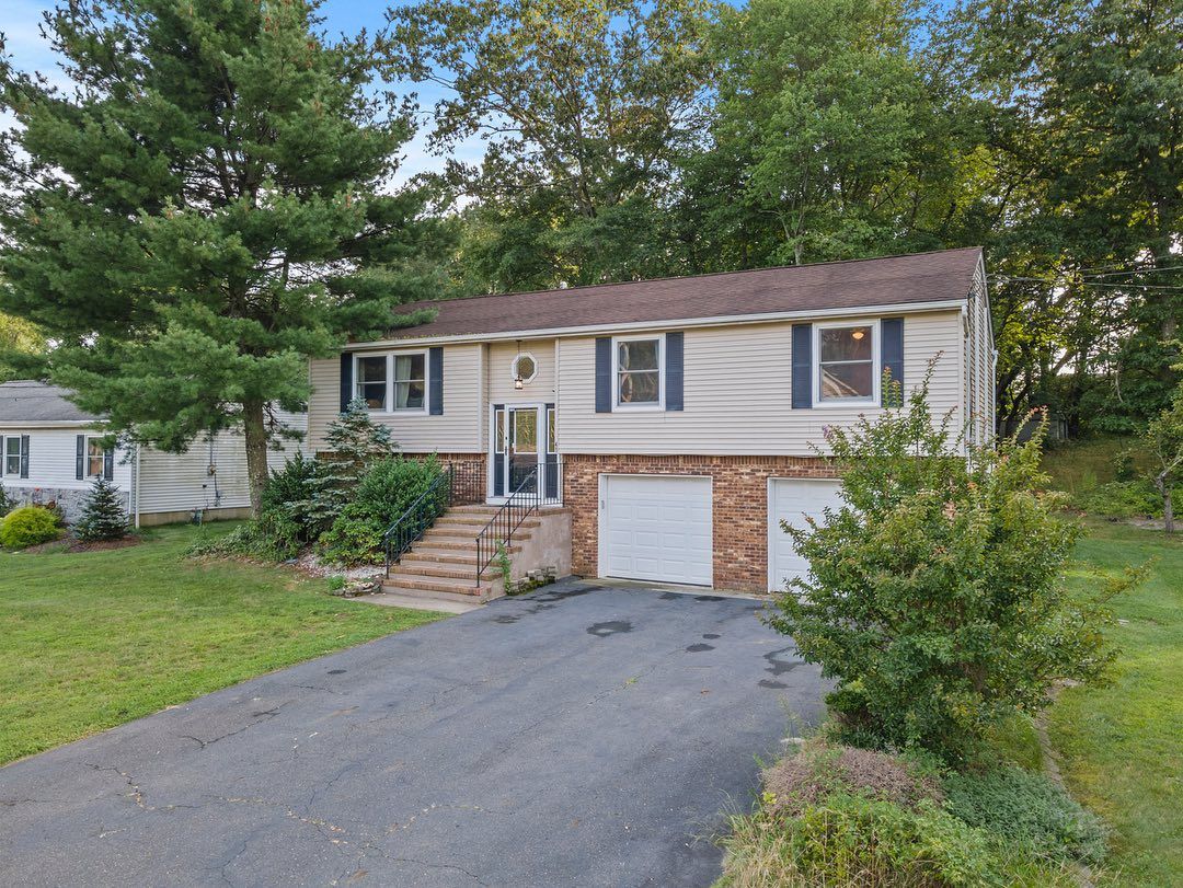 Split-level home with two-car garage and mature trees